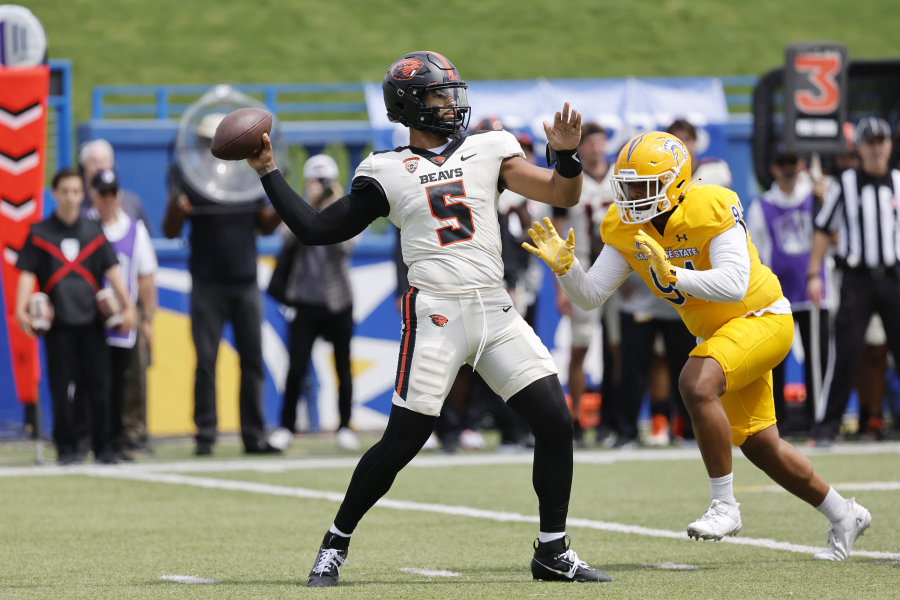 Oregon State quarterback DJ Uiagalelei (5) throws the ball as San Jose State defensive lineman Mata Hola (94) approaches in the first half of an NCAA college football game in San Jose, Calif., Sunday, Sept. 3, 2023.
