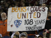 An Oregon State fans hold a "Pac-2" sign, representing the two schools that will remain in the Pac-12 after the 2023-2024 academic year after the other schools in the conference announced plans to leave, during the second half of an NCAA college football game between Washington State and Oregon State, Saturday, Sept. 23, 2023, in Pullman, Wash.