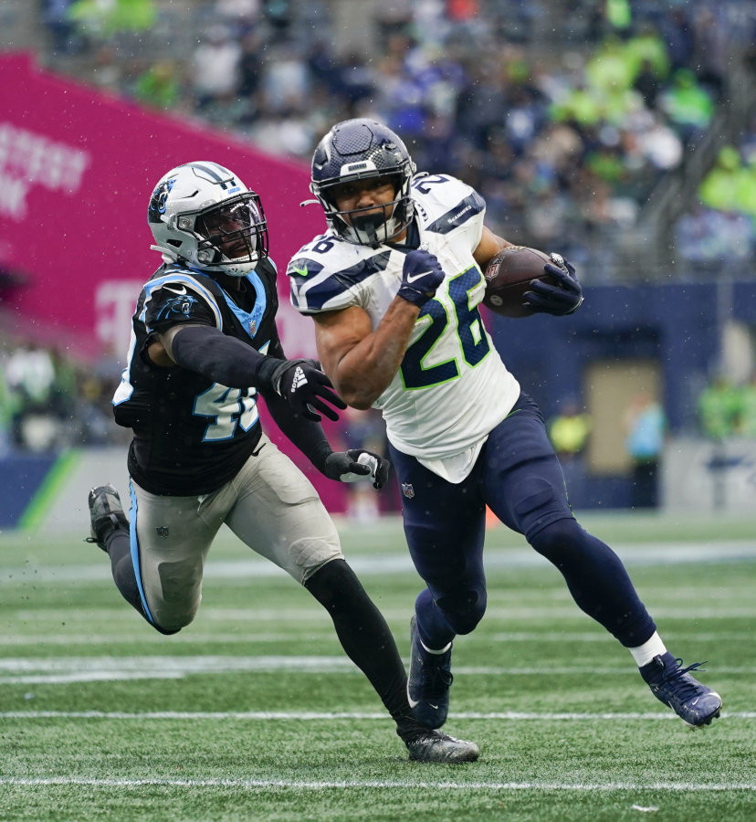 Seattle Seahawks running back Zach Charbonnet runs the ball against Carolina Panthers linebacker Deion Jones (40) during an NFL football game Sunday, Sept. 24, 2023, in Seattle. The Seahawks won 37-27.