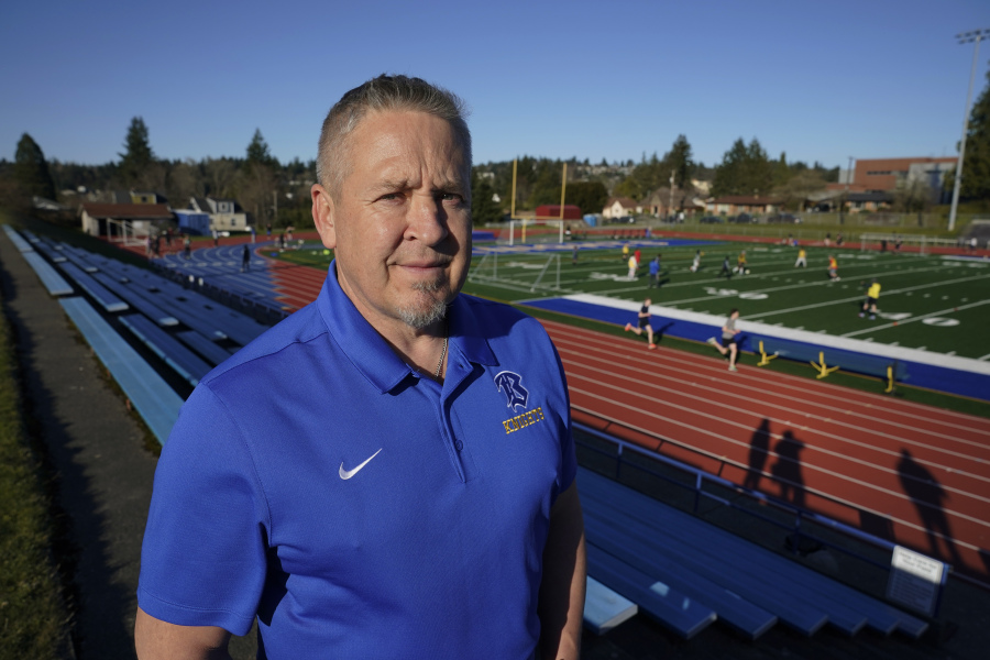 FILE - Joe Kennedy, a former assistant football coach at Bremerton High School in Bremerton, Wash., poses for a photo March 9, 2022, at the school's football field. Kennedy, the praying football coach who had a long legal battle to get his job back, resigned Wednesday, Sept. 6, 2023, after his first game back on the job. He cited multiple reasons for his resignation including taking care of an ailing family member out of state. (AP Photo/Ted S.