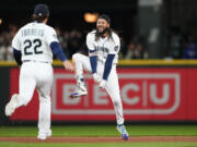 Seattle Mariners' J.P. Crawford, right, celebrates his game-winning, two-run double with Luis Torrens (22) against the Texas Rangers during the ninth inning of a baseball game Thursday, Sept. 28, 2023, in Seattle.