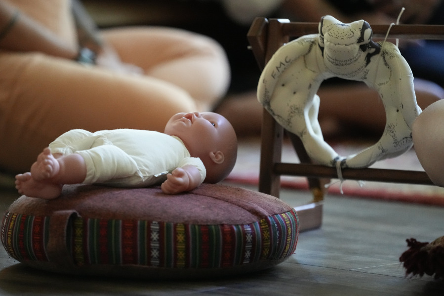 A doll and a model of the birthing canal is seen during a prenatal group meeting at The Farm Midwifery Center, Thursday, Aug. 31, 2023, in Summertown, Tenn. The Farm said fewer than 2% of clients end up having C-sections, and a report on deliveries in its first 40 years showed 5% of clients were transported to the hospital -- which midwife Corina Fitch said can happen because of things like water breaking early or exhaustion during labor. Clients usually give birth at The Farm or in their own homes.