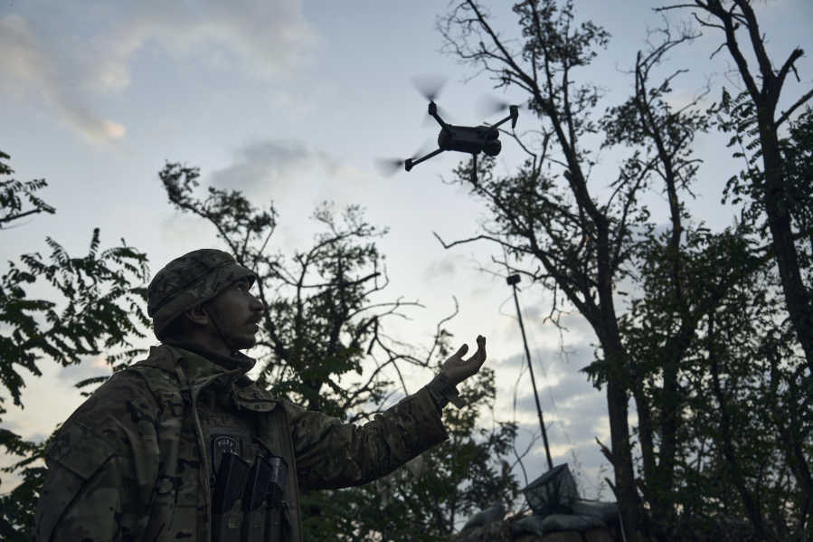 A soldier of Ukraine's 3rd Separate Assault Brigade launches a drone near Bakhmut, the site of fierce battles with the Russian forces in the Donetsk region, Ukraine, Sunday, Sept. 3, 2023.