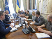 NATO Secretary General Jens Stoltenberg, center left, and Ukrainian President Volodymyr Zelenskyy center right, talk during their meeting in Kyiv, Ukraine, Thursday, Sept. 28, 2023.