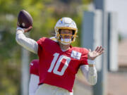 Los Angeles Chargers quarterback Justin Herbert throws during a joint NFL football practice with the New Orleans Saints, Thursday, Aug. 17, 2023, in Costa Mesa, Calif.