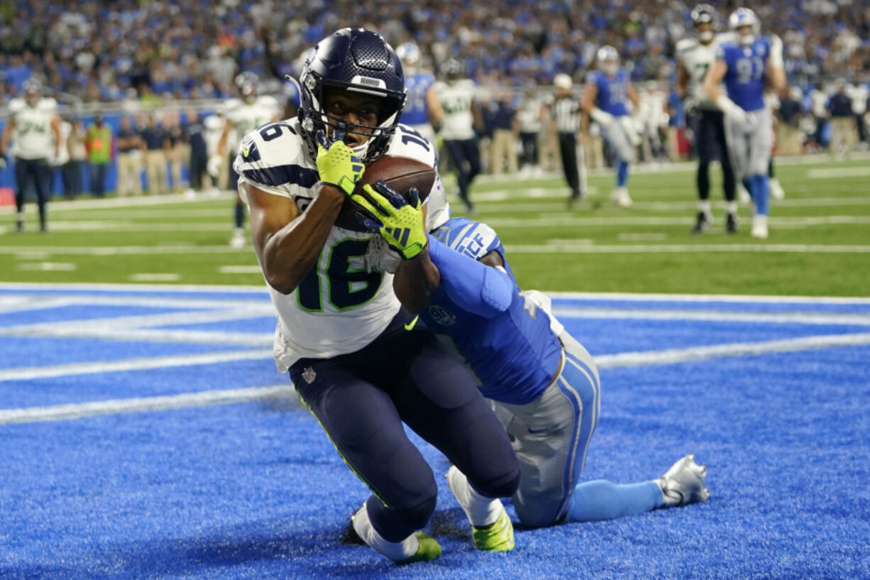 Seattle Seahawks wide receiver Tyler Lockett (16) catches a 3-yard touchdown pass in front of Detroit Lions cornerback Jerry Jacobs during the second half of an NFL football game, Sunday, Sept. 17, 2023, in Detroit.