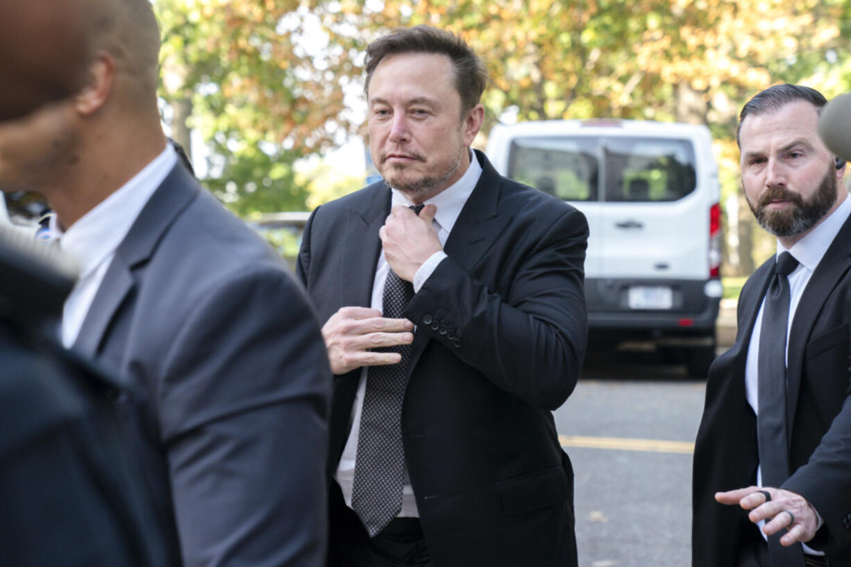 Elon Musk, CEO of X, the company formerly known as Twitter, tightens his tie as he arrives for a closed-door gathering of leading tech CEOs to discuss the priorities and risks surrounding artificial intelligence and how it should be regulated, at Capitol Hill in Washington, Wednesday, Sept.