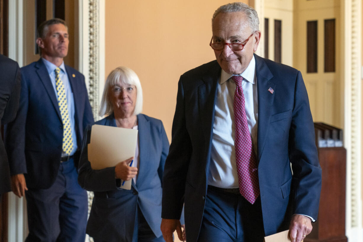 Senate Majority Leader Chuck Schumer of N.Y., right, followed by Sen. Patty Murray, D-Wash., walks to speaks to members of the media, Tuesday, Sept. 12, 2023, on Capitol Hill in Washington.