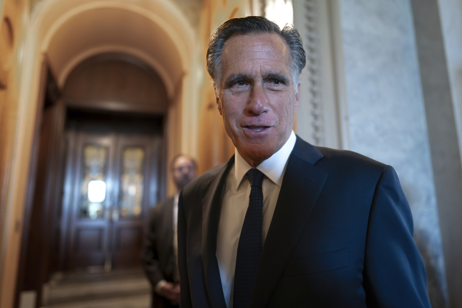 Sen. Mitt Romney, R-Utah, and other senators arrive at the chamber for votes, at the Capitol in Washington, Wednesday, Sept. 6, 2023. (AP Photo/J.