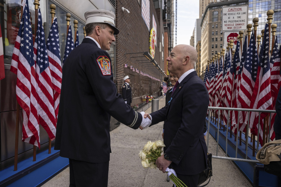 Secretary of Homeland Security Alejandro Mayorkas shakes hand with a firefighter outside the FDNY Ten House near the commemoration ceremony on the 22nd anniversary of the September 11, 2001, terror attacks on Monday, Sept. 11, 2023, in New York.