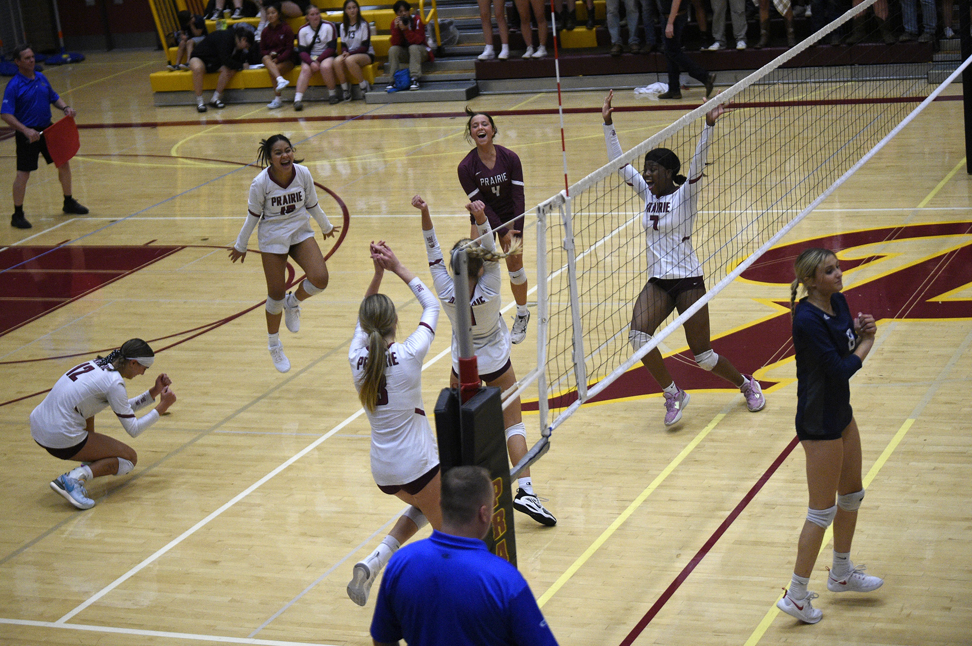 The members of the Prairie volleyball team celebrate the winning point of the second set against Skyview in a volleyball match at Prairie High School on Thursday, Sept. 14, 2023.