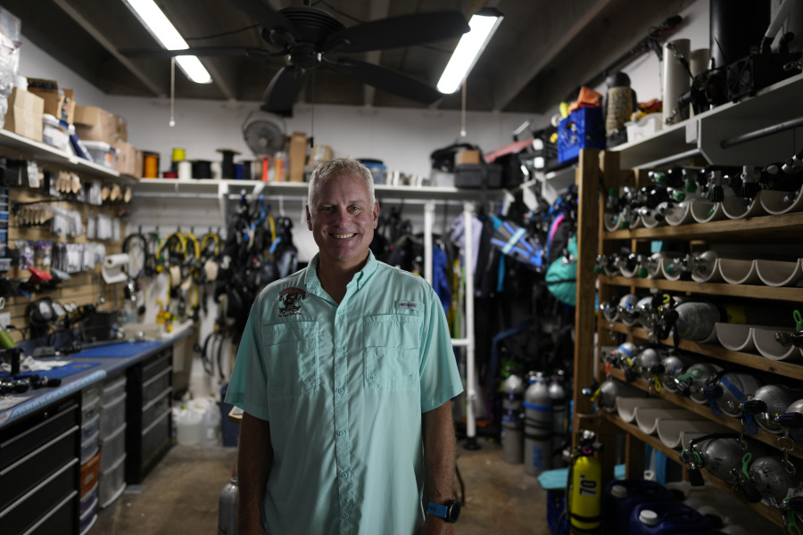 Dan Dawson, owner of Horizon Divers, poses for a picture in the rental equipment area of his dive shop in Key Largo, Fla., Thursday, Aug. 17, 2023. Dawson saw business boom during the pandemic. Now it's back to pre-pandemic levels.