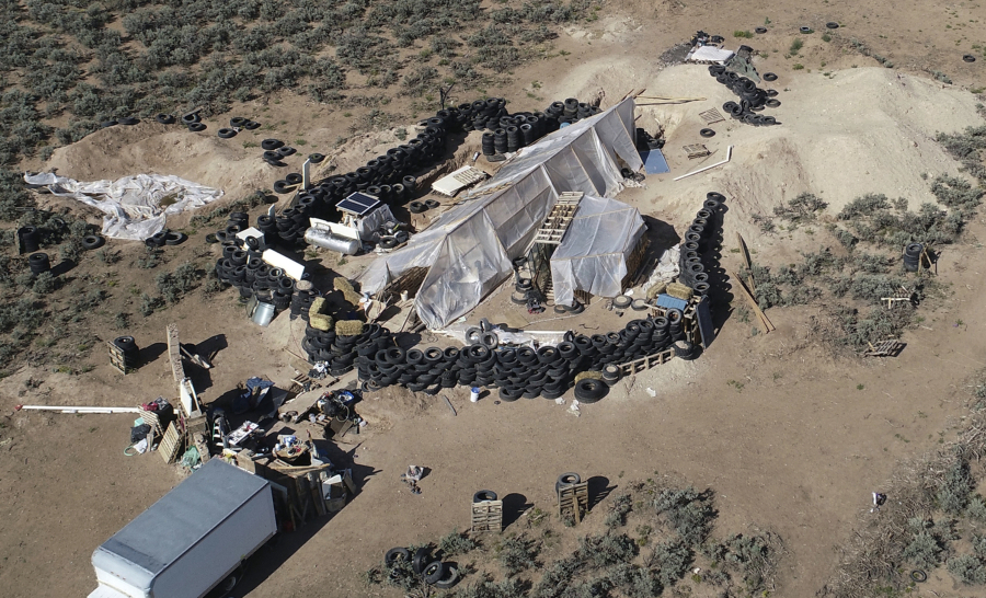FILE - A ramshackle compound is seen in the desert area of Amalia, N.M., on Aug. 10, 2018. Two firearms charges were dismissed Thursday, Sept. 21, 2023, amid preparations for trial against an extended family arrested in a 2018 law enforcement raid on the compound in northern New Mexico and the discovery of a young boy's decomposed body.