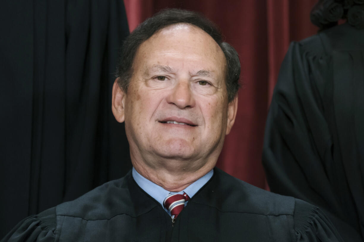 FILE - Associate Justice Samuel Alito joins other members of the Supreme Court as they pose for a new group portrait, Oct. 7, 2022, at the Supreme Court building in Washington. Alito on Friday, Sept. 8, 2023, rejected demands from Senate Democrats that he step aside from an upcoming Supreme Court case because of his interactions with one of the lawyers, in a fresh demonstration of tensions over ethical issues. (AP Photo/J.