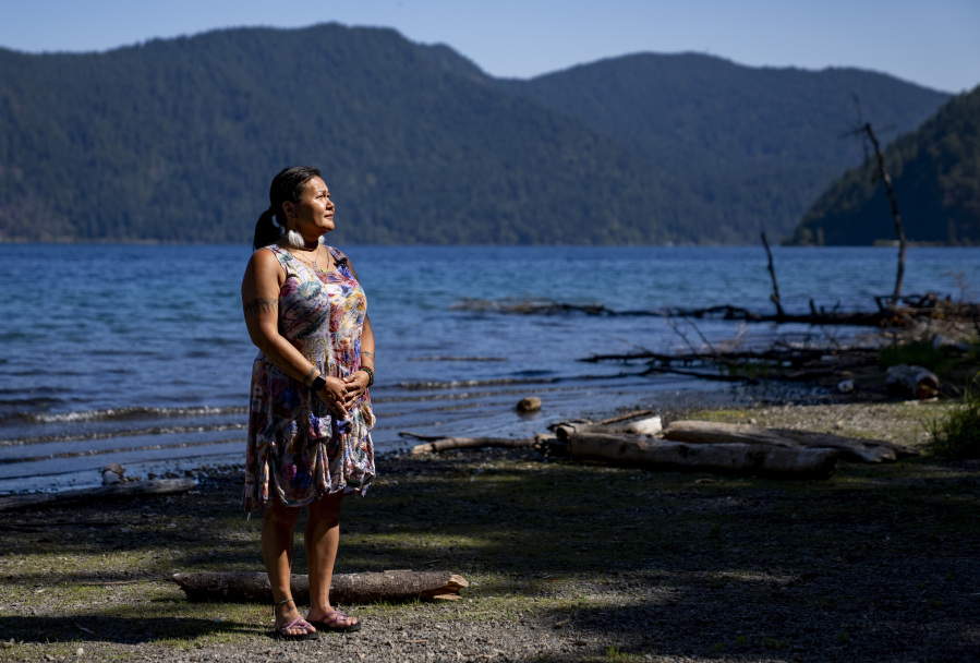 Jeanette Kiokun, the tribal clerk for the Qutekcak Native Tribe in Seward, Alaska, poses for a portrait on the shore of Lake Crescent at NatureBridge in the Olympic National Park during the 2023 Tribal Climate Camp, Thursday, Aug. 17, 2023, near Port Angeles, Wash. Participants representing at least 28 tribes and intertribal organizations gathered to connect and share knowledge as they work to adapt to climate change that disproportionally affects Indigenous communities. More than 70 tribes have taken part in the camps that have been held across the United States since 2016.