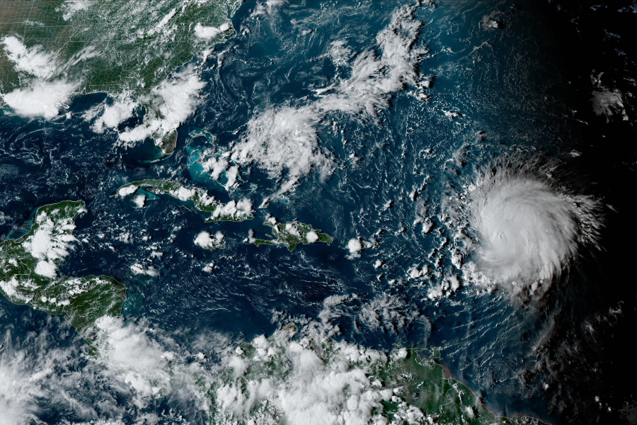 This satellite image provided by the National Oceanographic and Atmospheric Administration shows Hurricane Lee, right, on Friday, Sept. 8, 2023, at 4:50 p.m. EDT.