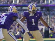 Washington wide receiver Rome Odunze (1) celebrates after his touchdown against Tulsa with teammate Germie Bernard (4) during the second half of an NCAA college football game Saturday, Sept. 9, 2023, in Seattle.