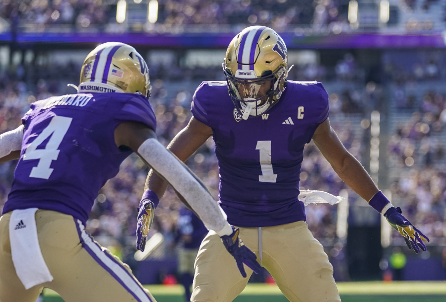 Washington wide receiver Rome Odunze (1) celebrates after his touchdown against Tulsa with teammate Germie Bernard (4) during the second half of an NCAA college football game Saturday, Sept. 9, 2023, in Seattle.