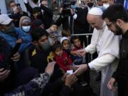 Pope Francis meets migrants during his visit at the Karatepe refugee camp, on the northeastern Aegean island of Lesbos, Greece, Dec. 5, 2021.Ten years after Pope Francis made a landmark visit to the Italian island of Lampedusa to show solidarity with migrants, he is joining Catholic bishops from around the Mediterranean this weekend in France to make the call more united, precisely at the moment that European leaders are again scrambling to stem the tide of would-be refugees setting off from Africa.
