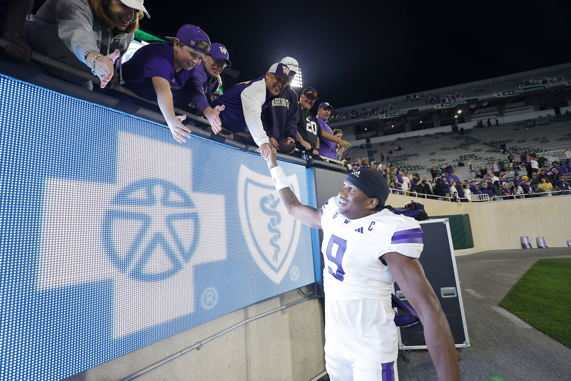 Washington's Michael Penix Jr. greets fans following an NCAA college football game against Michigan State, Saturday, Sept. 16, 2023, in East Lansing, Mich. Washington won 41-7.