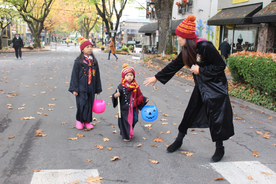 A Hogwarts family makes their way down Northeast Fourth Avenue in Camas during the 2018 Boo Bash. Pictured: Mom Kelly (right) with her two children, Julamani, 6 (left), and Jameson, 3 (center).