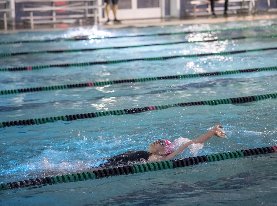 La Center sophomore Sonja Austad backstrokes through the water Thursday, Sept. 28, 2023, during swim practice at Gold's Gym Camas. Austad — diagnosed with cerebral palsy at 18 months old — thrives on La Center's two-person swim team.