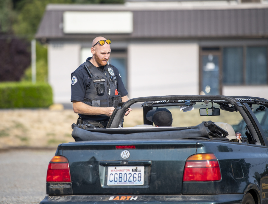 Vancouver police Officer Sean Donaldson, right, pulled over a driver who came speeding down St. Johns Road one day in late August. The car turned out to be stolen and there were warrants out for the driver's arrest.