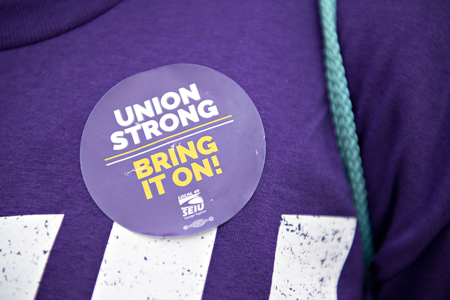 "Union strong, bring it on," reads the sticker on a member of Service Employees International Union  Local 49. Many family members of health care workers came out in solidarity.