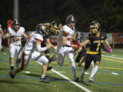 Eagles' Rafael Bauman, right, evades Panthers' defenders for a first down at Kiggens Bowl on Friday, Oct. 6, 2023.