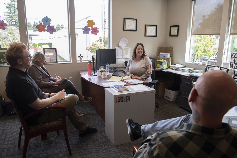 Chaplain Jon Nichols, from left, chats with operations manager Claudia Merritt and Renee Stevens, who went from being homeless to being executive director of Open House Ministries, during a staff meeting in her office.