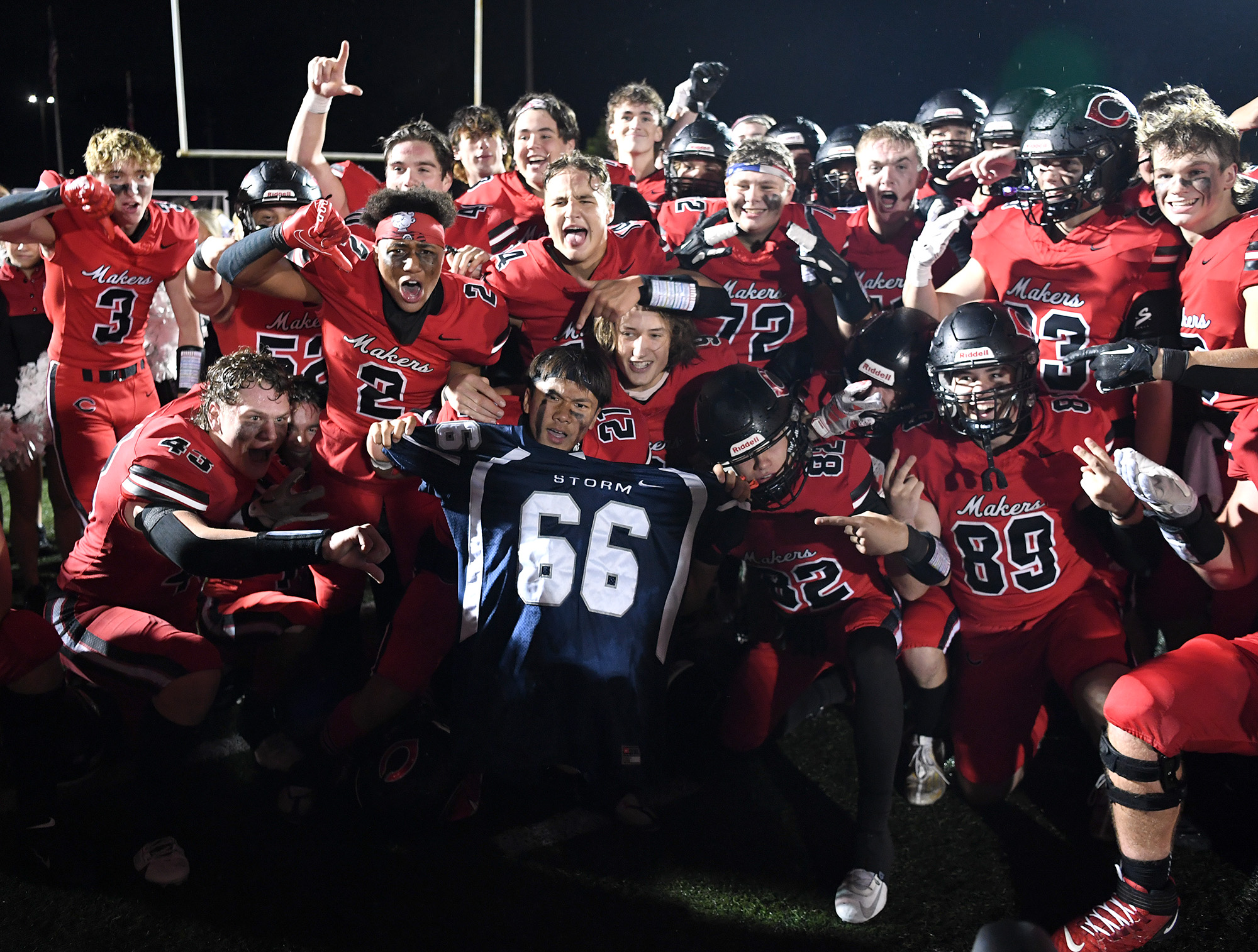 Camas players pose with a Skyview jersey Friday, Oct. 13, 2023, after the Papermakers’ 21-9 win against Skyview at Doc Harris Stadium in Camas.
