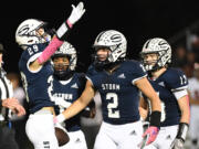 Skyview junior Micah Robison, left, celebrates an interception with teammates Friday, Oct. 20, 2023, during Skyview’s 49-10 win against Battle Ground at Kiggins Bowl.