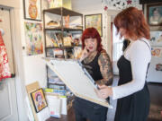 Artists Pamela Sue Johnson, left, and Annika Larman examine a painting by Larman at Johnson's studio in Vancouver. Larman is the first recipient of Open Studios' new artist scholarship and Johnson is her artist mentor for the year.