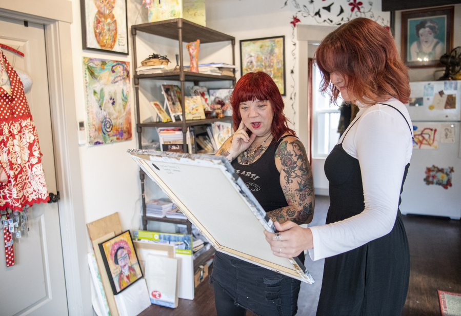 Artists Pamela Sue Johnson, left, and Annika Larman examine a painting by Larman at Johnson's studio in Vancouver. Larman is the first recipient of Open Studios' new artist scholarship and Johnson is her artist mentor for the year.