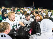 Woodland senior Carter Conway, from left, junior Charles Elkinton, sophomore Isaiah Mattison, and other players celebrate Friday, Oct, 27, 2023, after the Beavers’ 28-21 win against Ridgefield at Ridgefield High School. With the win, Woodland captured its first 2A Greater St. Helens League title since 2007.