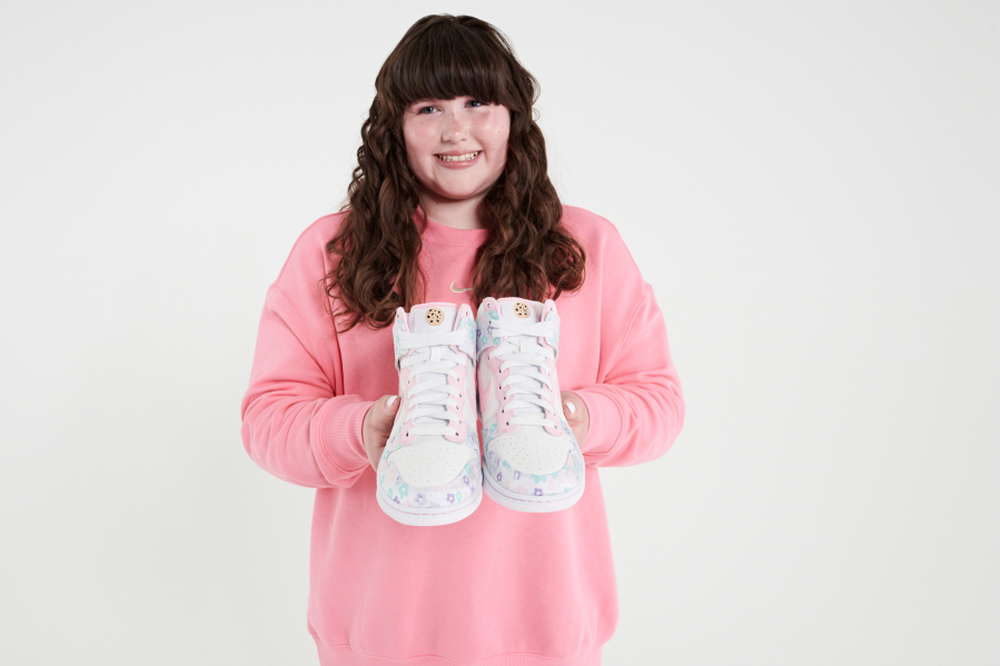 Macey Bodily of Yacolt, 15, holds her custom-designed shoes for the Doernbecher Freestyle Auction. Macey was one of six young designers who created shoes and apparel for this freestyle collection.