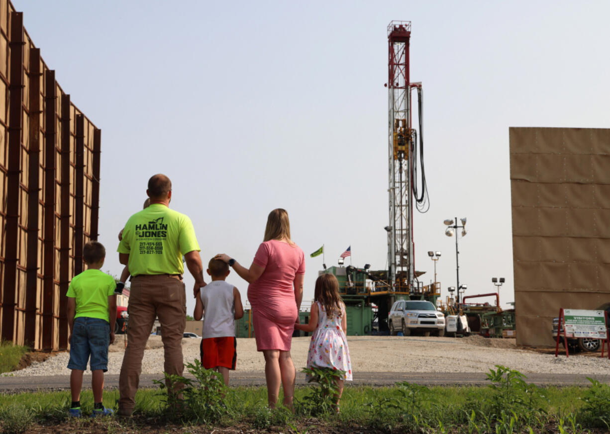 Ralph and Sabrina Jones stand with their children across the road from the Navigator CO2 drilling site on July 24, 2023, in Nokomis, Illinois.