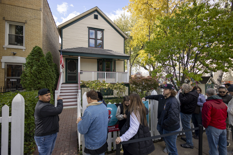 Visitors line up to enter the birthplace of Walt Disney at the corner of North Tripp Avenue and West Palmer Street in Chicago's Hermosa neighborhood.