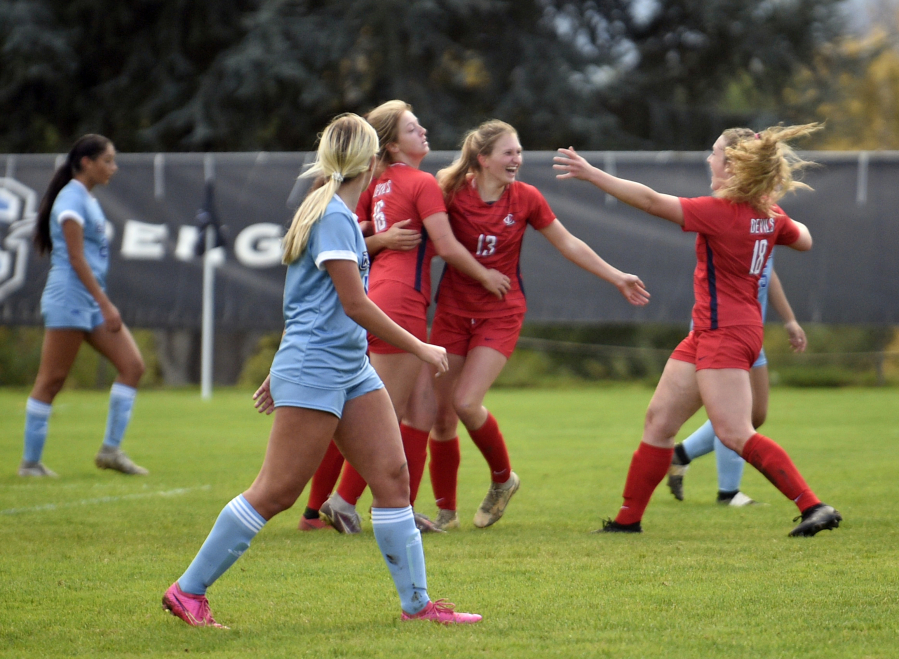 Lower Columbia College's Sydney Lulay (13) celebrates with teammates Rhyli Grim (16) and Molly Romanchock (18) after scoring the Red Devils' first goal in an NWAC women's soccer match on Wednesday, Oct. 25, 2023, at Kim Christensen Field.