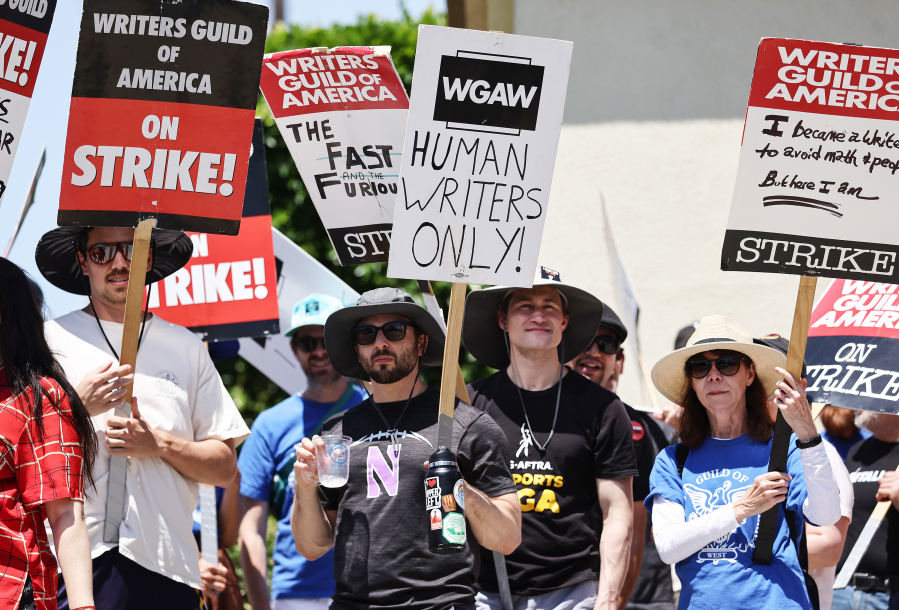 A sign reads ''Human Writers Only!" as striking WGA (Writers Guild of America) workers picket outside Paramount Studios on July 12, 2023, in Los Angeles.