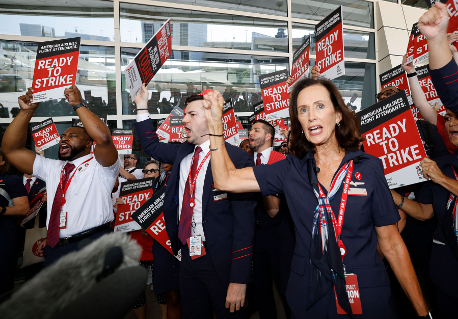 Julie Hedrick, president at Association of Professional Flight Attendants and also American Airlines flight attendant, right, shout slogans, as American Airlines flight attendants, and their supporters picket outside of Terminal D at Dallas-Fort Worth International Airport on Aug. 30, 2023.