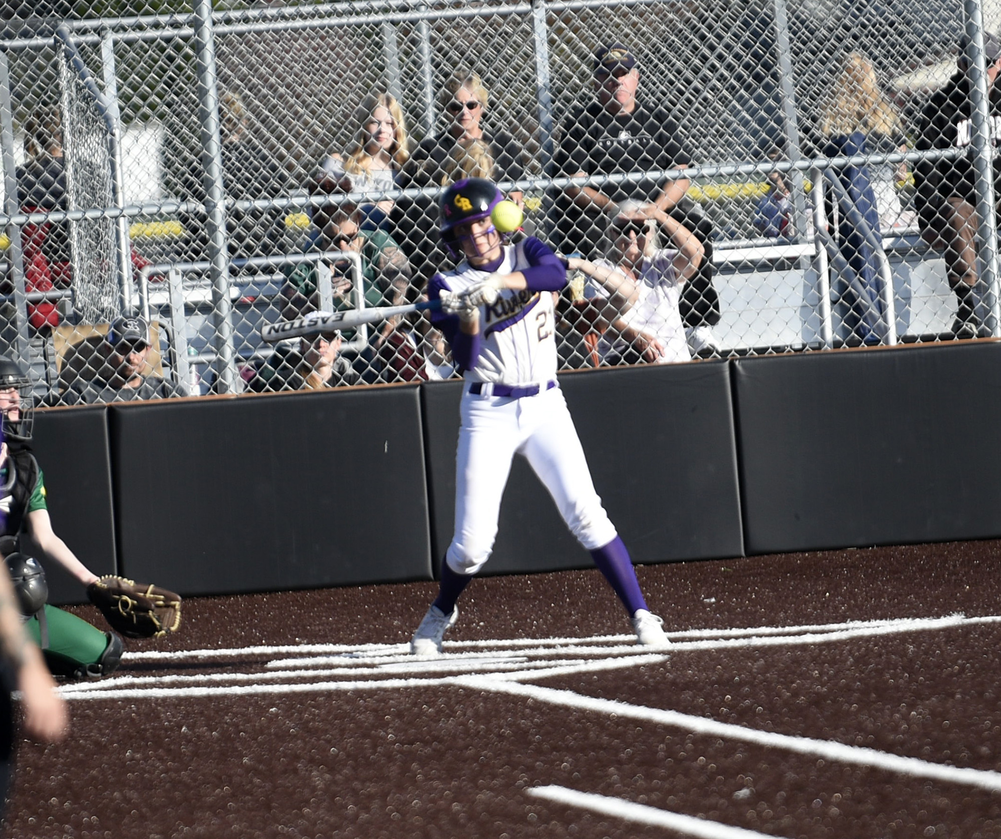 Mia Yanez of Columbia River watches the pitch come in before connecting for a hit against Evergreen in the 3A/2A slowpitch softball district tournament at Heritage High School on Friday, Oct. 20, 2023.