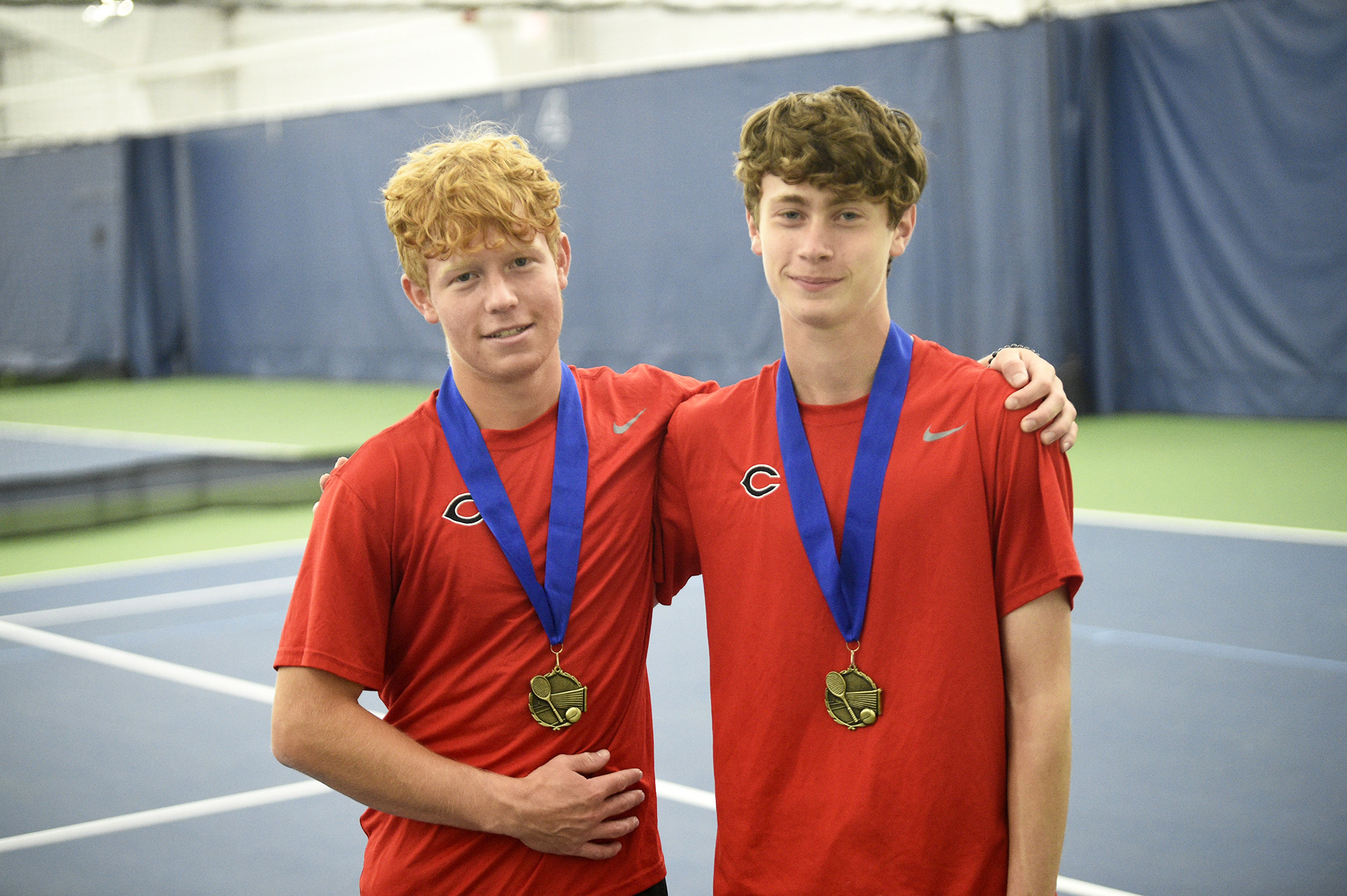 Camas players Tommy James (left) and Aidan Brasier pose with their medals after winning the doubles championship at the Class 4A boys tennis district tournament at Vancouver Tennis Center on Saturday, Oct. 21, 2023.
