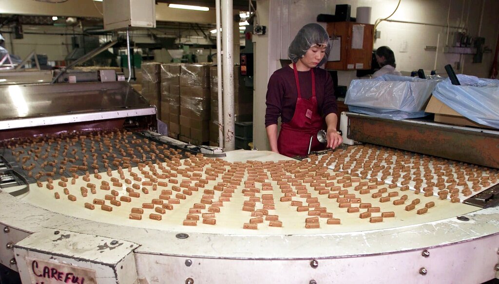 Almond Roca heads around a bend on the conveyor belt into the chocolate coating machine at candymaker Brown and Haley's Tacoma Wash. plant on Monday, June 12, 2000. J.C. Haley teamed up with candymaker and store owner  Harry L. Brown to start the company in 1914.