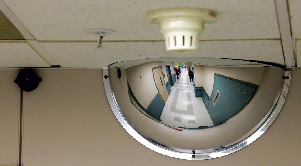 FILE - In this Nov. 18, 2015, file photo, a mirror on the ceiling of a hallway in a ward at the Western State Hospital in Lakewood, Wash. is shown. Hundreds of mentally ill patients at Washington state's largest psychiatric hospital are forced to live in conditions that don't meet federal health and safety standards, while overworked nurses and psychiatrists say they must navigate a management system that punishes whistleblowers and fires non-conformers, despite critical staffing shortages. For years, federal regulators have continuously cited the 800-bed facility for violating health and safety standards and a surprise inspection last month found that the hospital continues to put patients at risk. (AP Photo/Ted S.