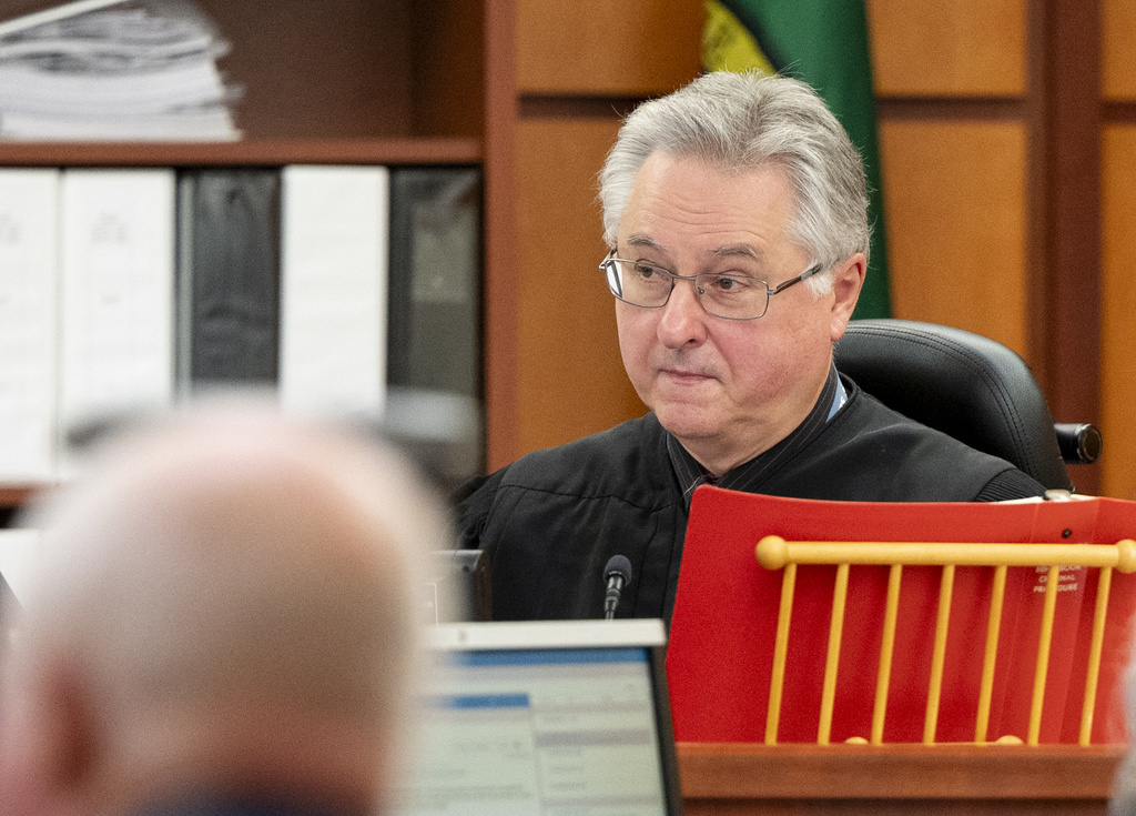 Judge Bryan Chushcoff presides as the state delivers opening remarks during the trial of Tacoma Police Officers Christopher Burbank, Matthew Collins and Timothy Rankine in the killing of Manny Ellis, Tuesday, Oct. 3, 2023, at Pierce County Superior Court, Tacoma, Wash.