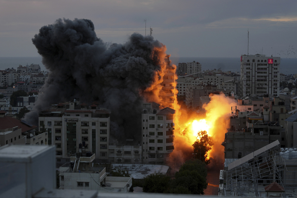 A ball of fire and smoke rise from an explosion on a Palestinian apartment tower following an Israeli air strike in Gaza City, Saturday, Oct. 7, 2023. The militant Hamas rulers of the Gaza Strip carried out an unprecedented, multi-front attack on Israel at daybreak Saturday, firing thousands of rockets as dozens of Hamas fighters infiltrated the heavily fortified border in several locations by air, land, and sea and catching the country off-guard on a major holiday.