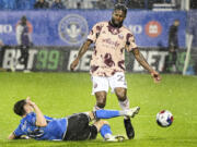 CF Montreal's Joel Waterman, left, challenges Portland Timbers' Dairon Asprilla, right, during second-half MLS soccer match action in the rain in Montreal, Saturday, Oct. 7, 2023.