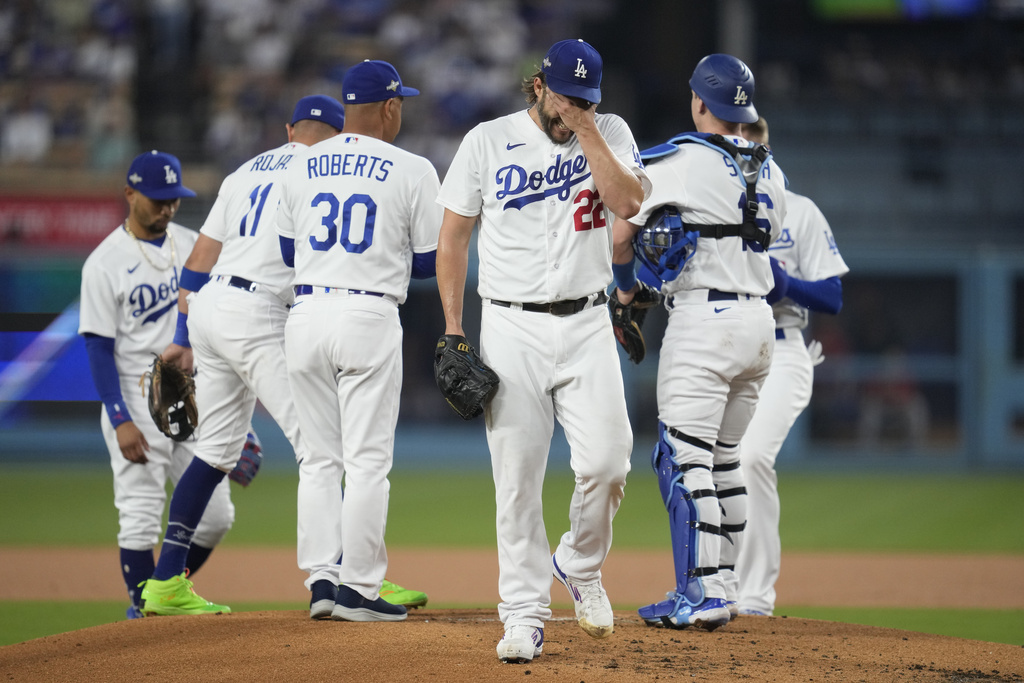 Los Angeles Dodgers starting pitcher Clayton Kershaw, center, reacts as he exits during the first inning in Game 1 of a baseball NL Division Series against the Arizona Diamondbacks, Saturday, Oct. 7, 2023, in Los Angeles.