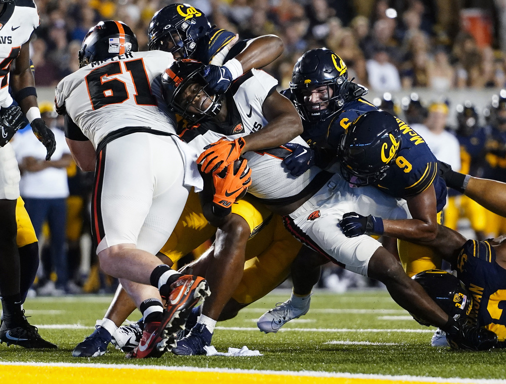 Oregon State running back Deshaun Fenwick (1) is tackled by California defenders short of the end zone during the first half of an NCAA college football game Saturday, Oct. 7, 2023, in Berkeley, Calif. (AP Photo/Godofredo A.